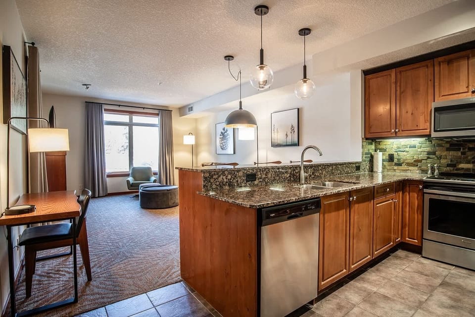 Open concept kitchen with workspace area leading into the dining and living room