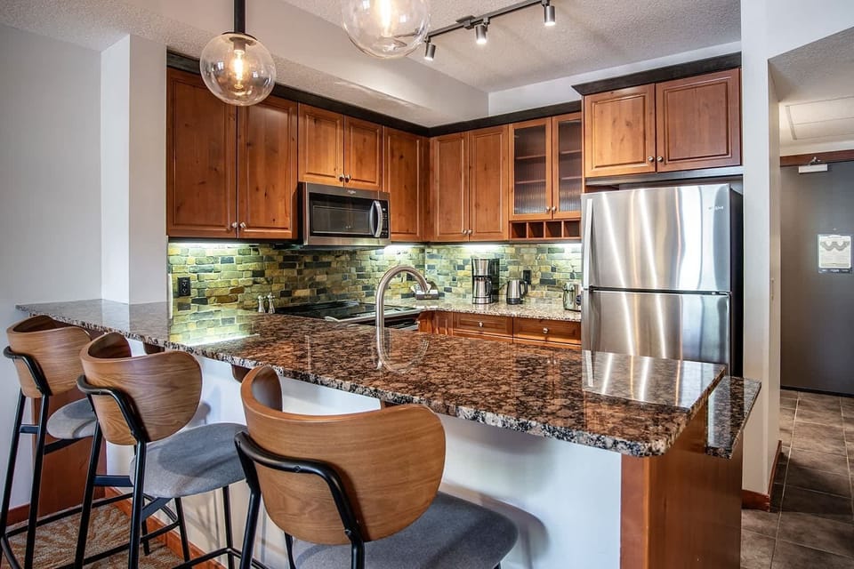 Chef's kitchen features a breakfast bar with seating for 3.