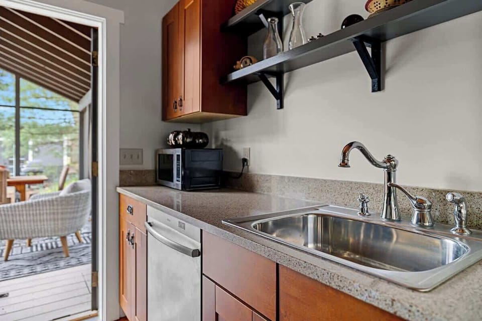 Just off the kitchen is a way-nicely furnished 3-Season porch and dining table.