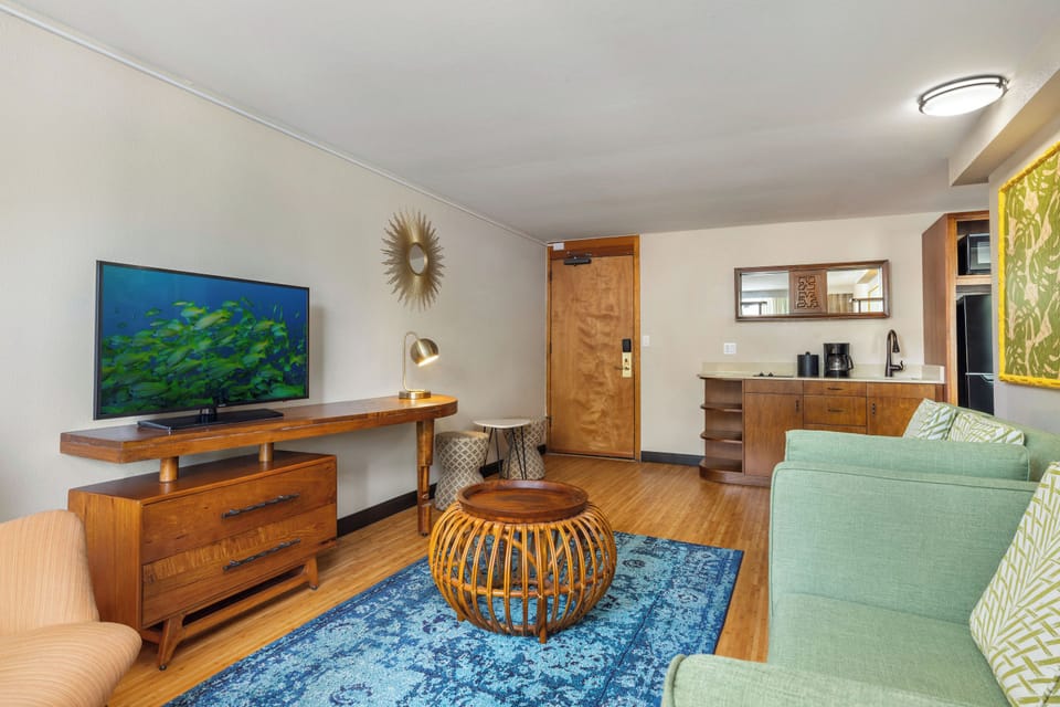 Settle into your inviting living space with warm wood accents, comfortable seating, and a large TV for your favorite shows. The fully equipped kitchenette makes it easy to prepare your morning coffee or evening snacks.
