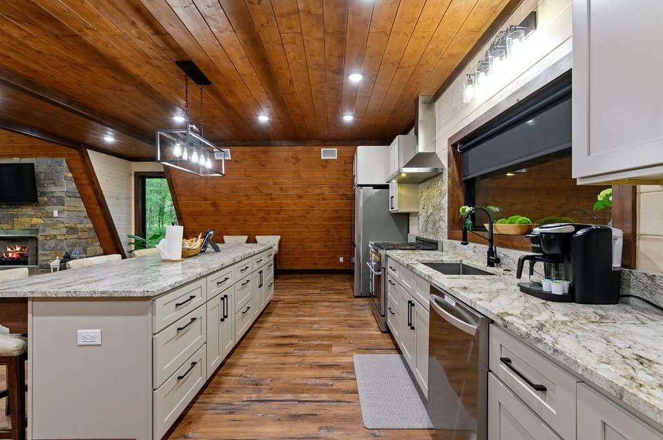 The kitchen sink looks out to the back deck with a gorgeous window so you don't miss a single moment of the surrounding pines.