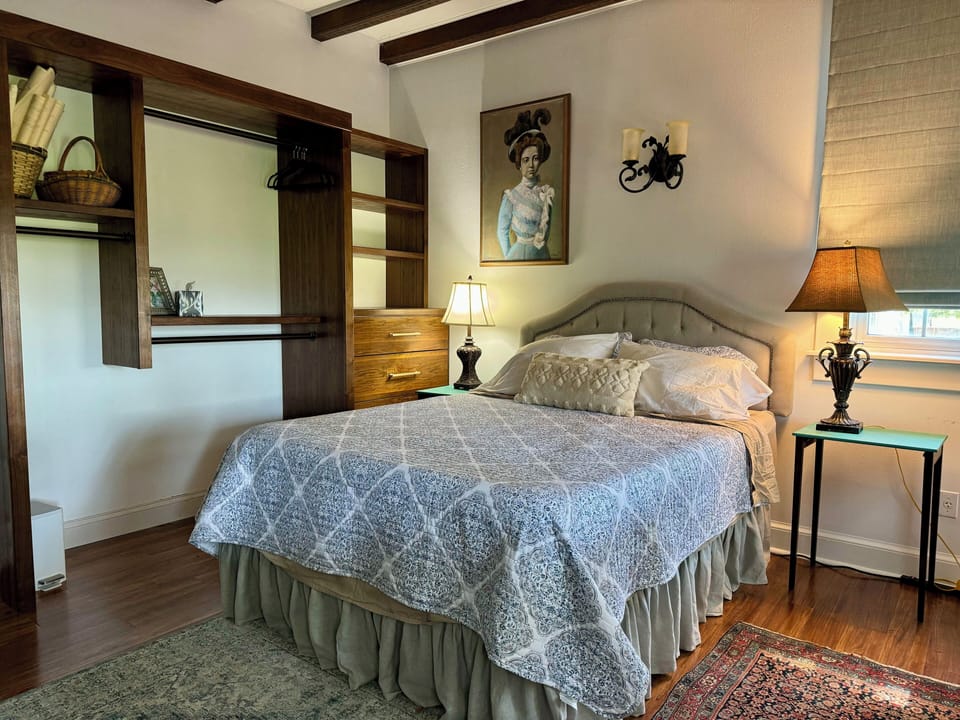 First-floor master bedroom (queen). Door to the deck on the right. 