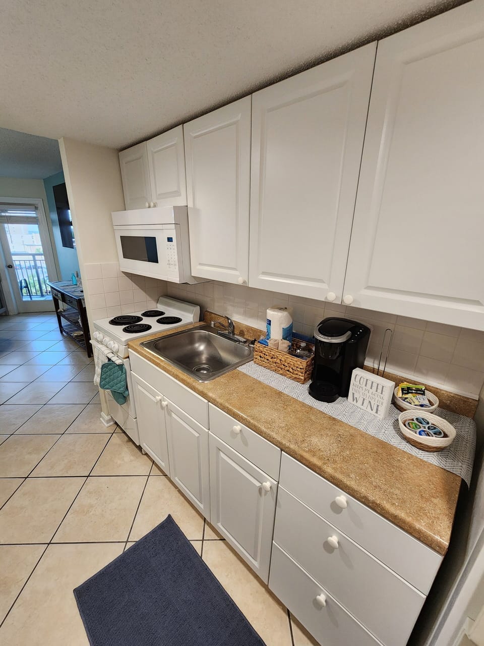 kitchen with full size refrigerator, sink, stove & microwave! 