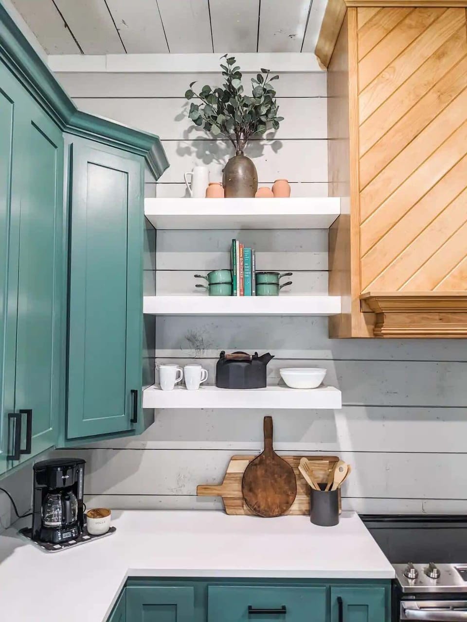 Coffee maker is available for use as well as plenty of coffee mugs on the floating shelves as well as inside the cabinets.