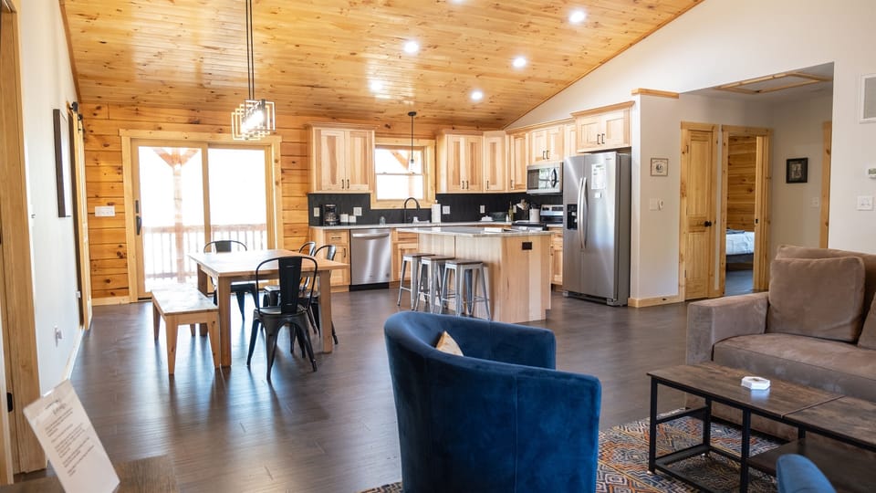 Open Concept: Fully stocked kitchen, dining area for 9 and cozy living area