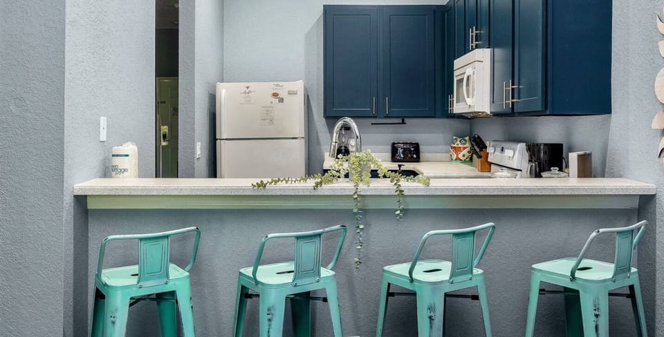 A cozy stool in front of the kitchen, perfect for sitting and chatting while meals are being prepared.
