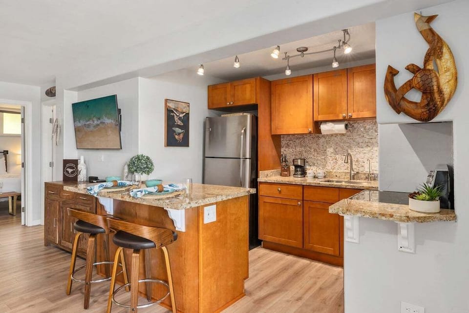 A beautiful kitchen featuring warm wood cabinetry and a breakfast bar for casual dining