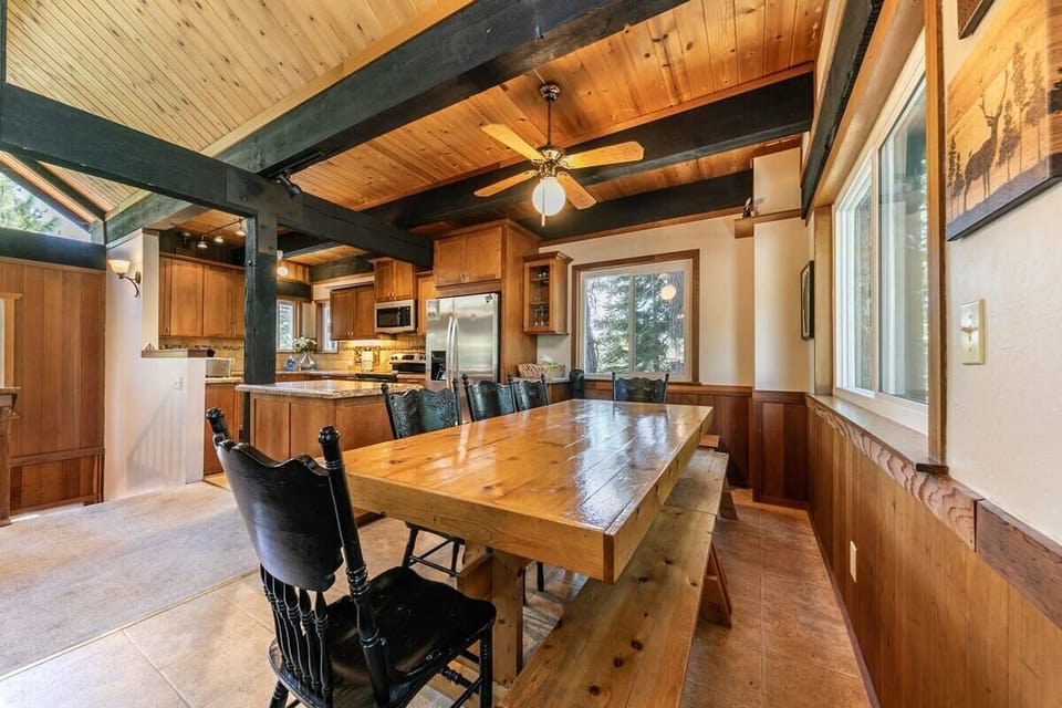 The home offers plenty of space for gathering for meals with a 9-person dining table and a kitchen island with 3 bar stools.