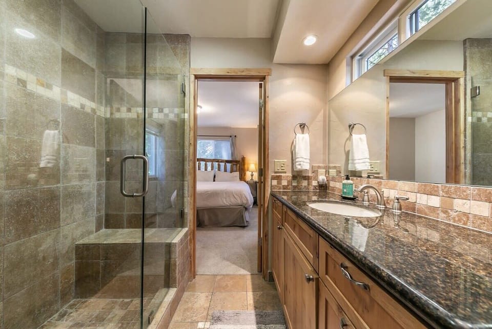 The master bathroom has a large single-sink vanity and a step-in shower.