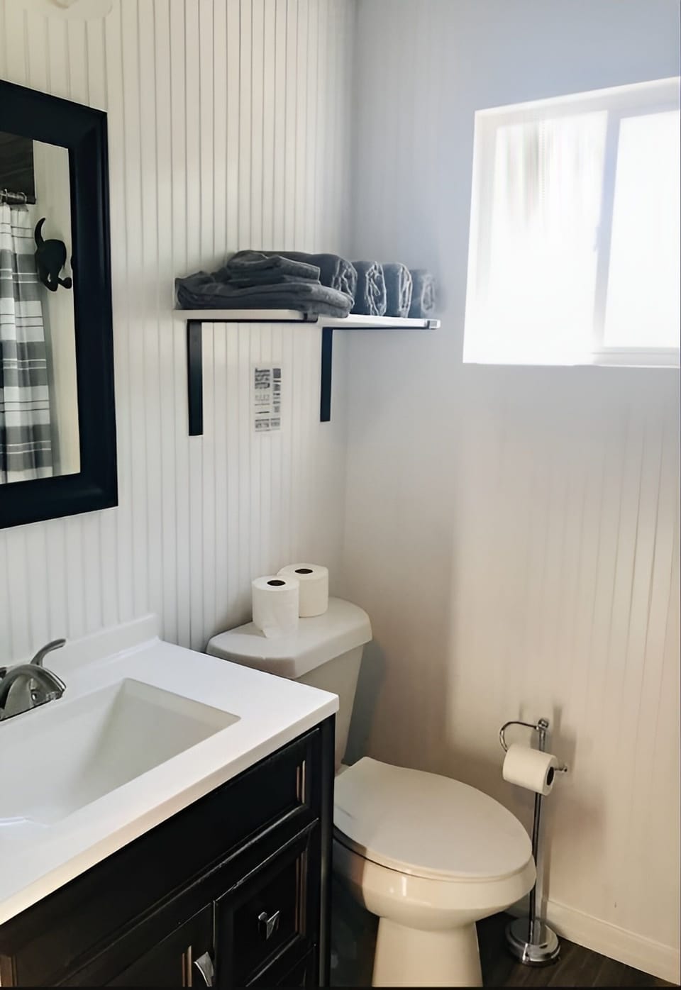 Refresh easily in the bright bath with stocked towel shelf.