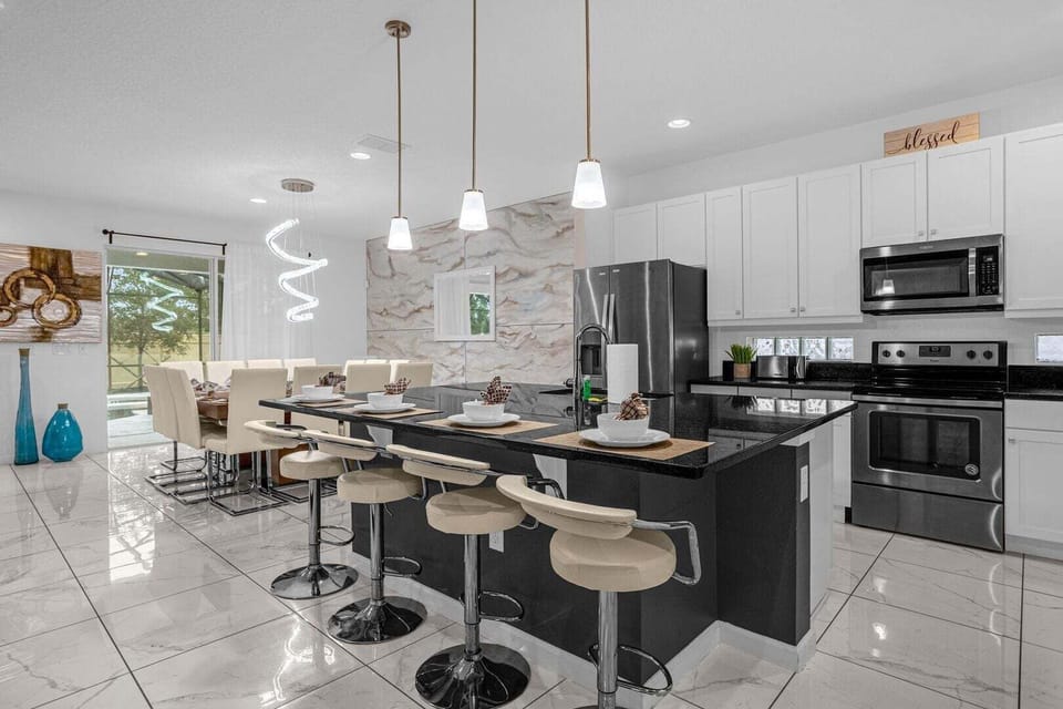 The living room, dining room, and kitchen seamlessly flow into one open space.