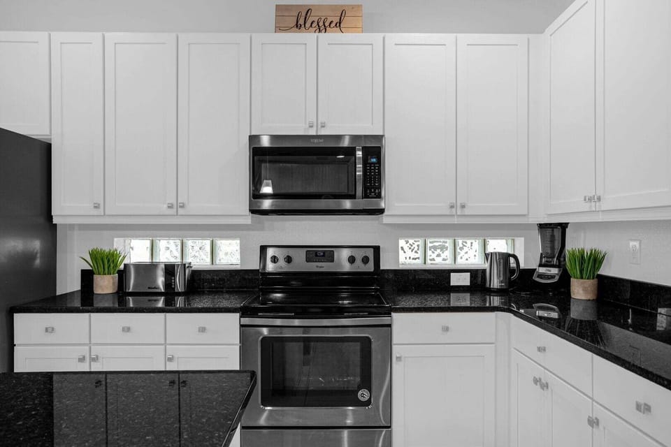 Fully equipped kitchen with stainless steel appliances.