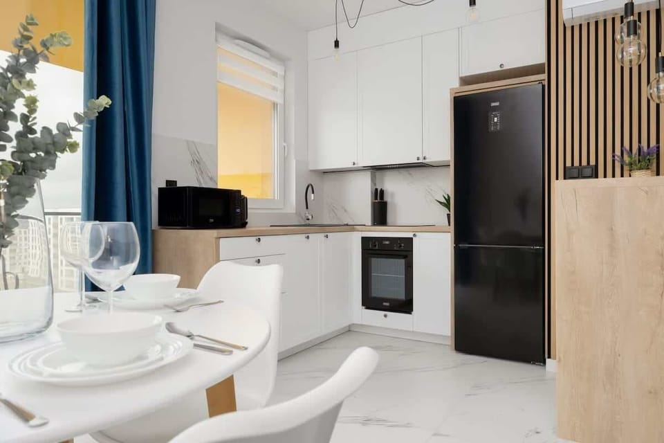 A fully equipped kitchenette with modern appliances and a sleek design. Perfect for preparing both quick snacks and full meals.