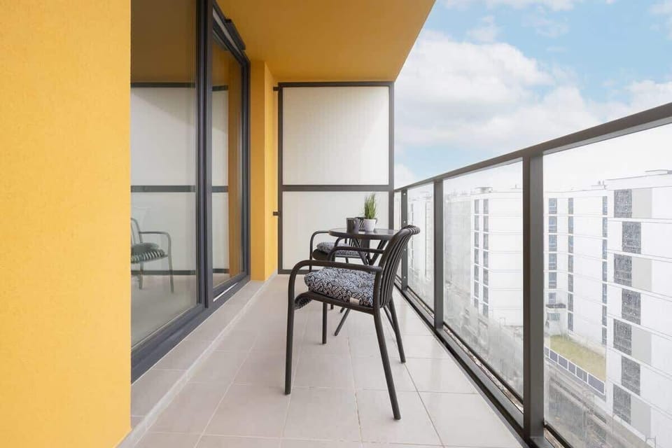 A furnished balcony with a small table and chairs. A perfect place to enjoy your morning coffee or evening breeze.