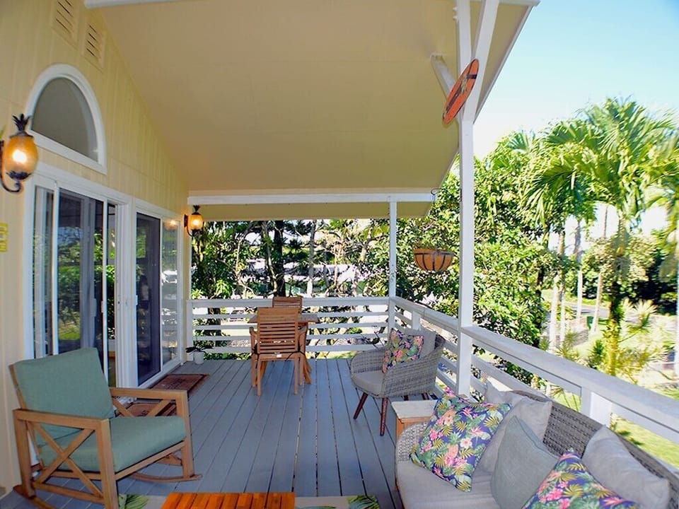 Lanai view - The lanai overlooks the stately private corner lot with many palm trees