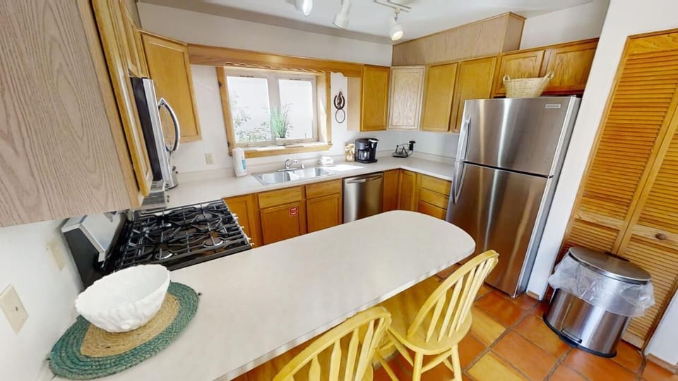 Cook up your vacation favorites in this bright, fully-equipped kitchen with stainless steel appliances, gas range, and ample counter space for meal prep.