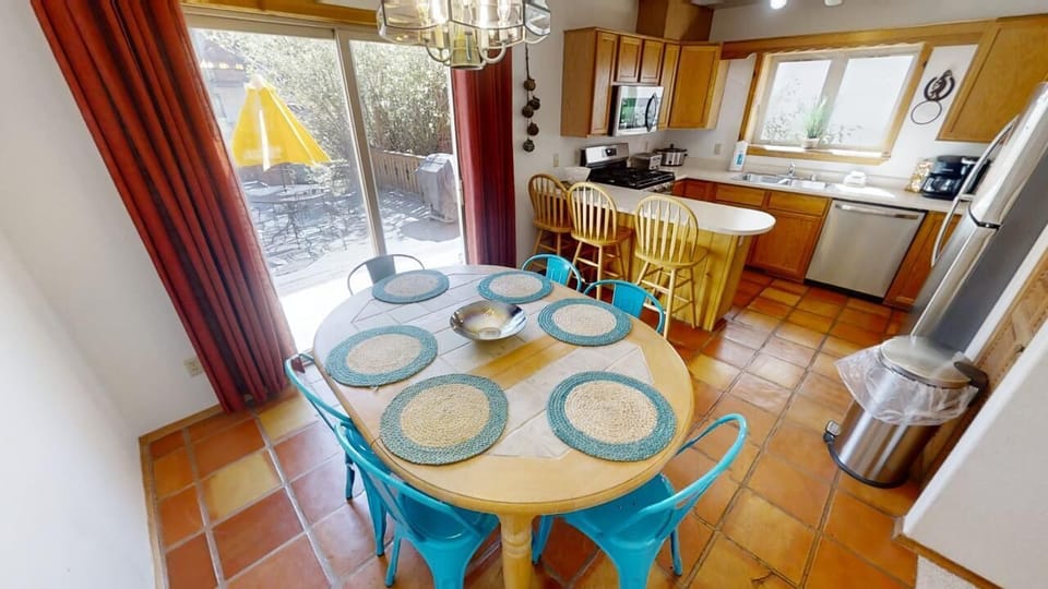 Gather around the bright dining table overlooking your private deck, or whip up meals in the well-equipped kitchen featuring natural light and modern appliances—perfect for home-cooked moments.