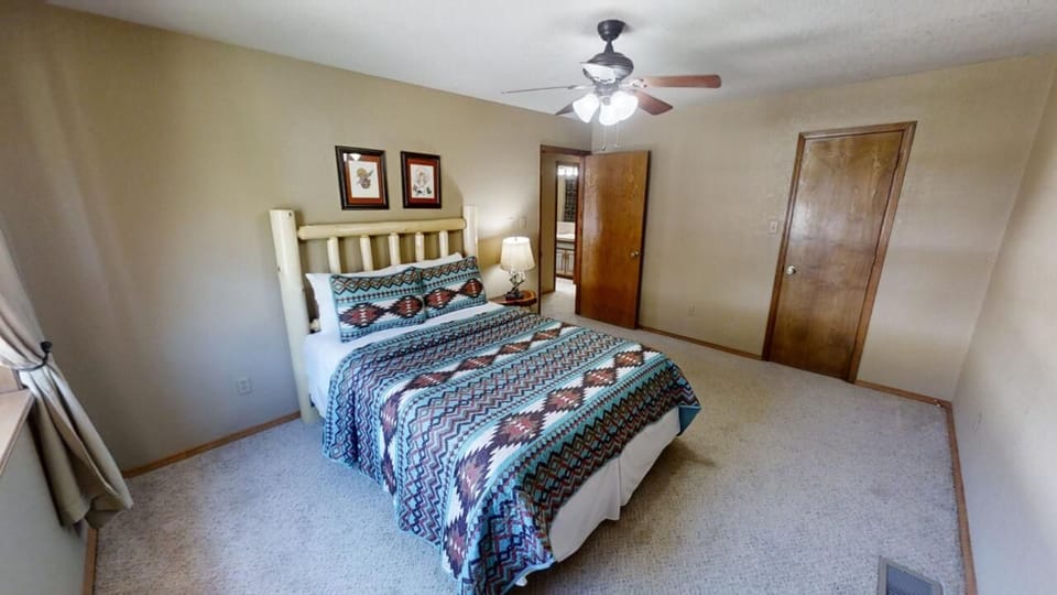 Sink into the cozy bed with Southwestern-style linens, unwind under the ceiling fan, and enjoy your peaceful retreat. Warm lighting and simple touches create a welcoming space for rest.