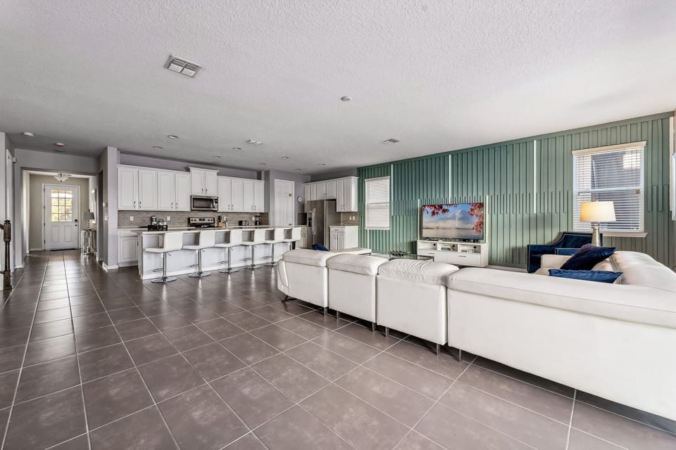 Wide living area w/ sleek floors and plenty of seating to unwind.