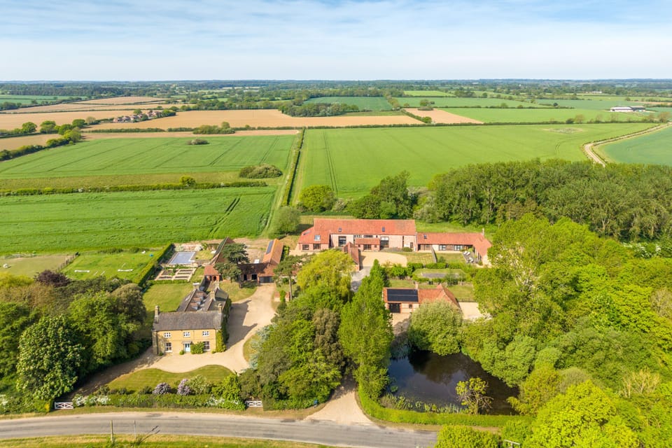 Aerial view of Tittleshall Barns with views of the rolling countryside