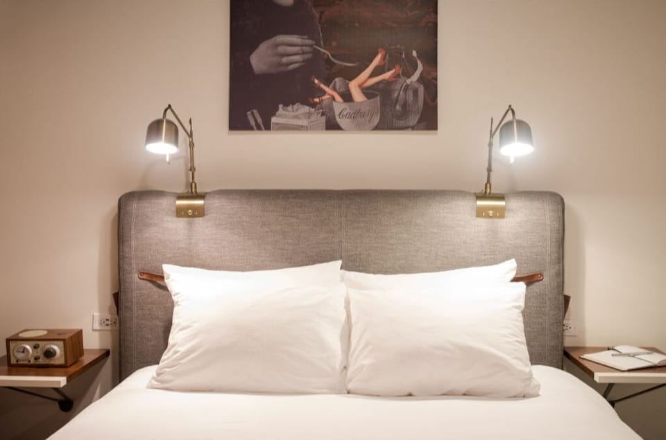 Restful bedroom setting with striking wall art and plush pillows