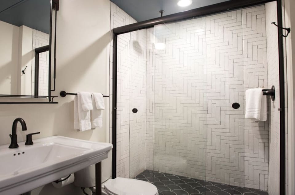 Airy and modern bathroom with expansive mirror and sleek vanity