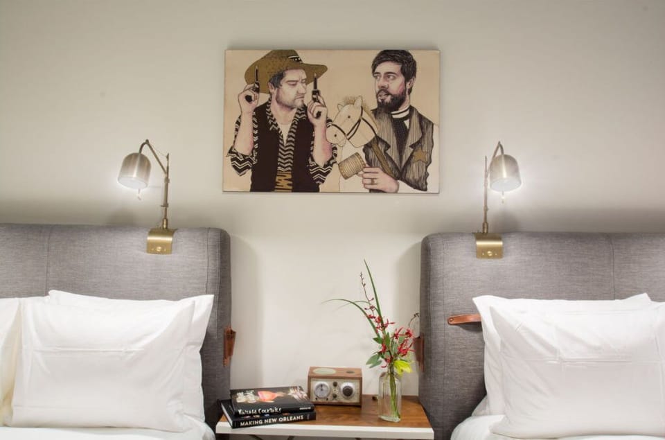 Sleek bedroom elegance punctuated by unique wall art