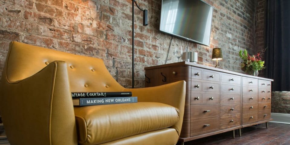 Leather armchair paired with a vintage chest of drawers for a retro vibe