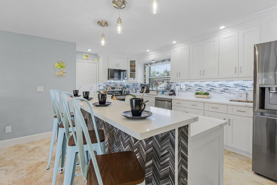 walk through kitchen with a large island. perfect for breakfasts and coffee in the morning.