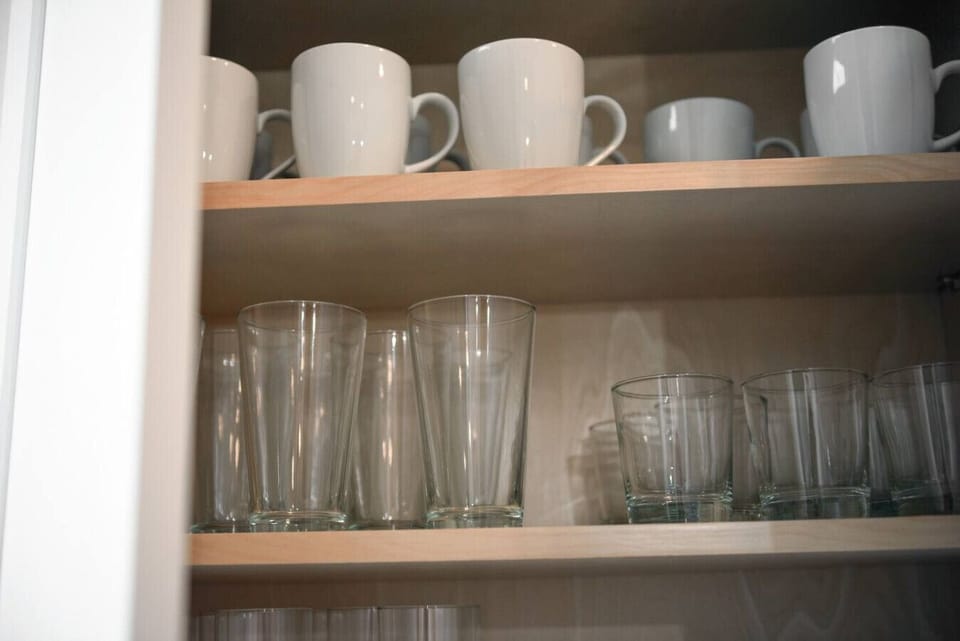 Well-organized glassware and mugs—everything ready for your stay