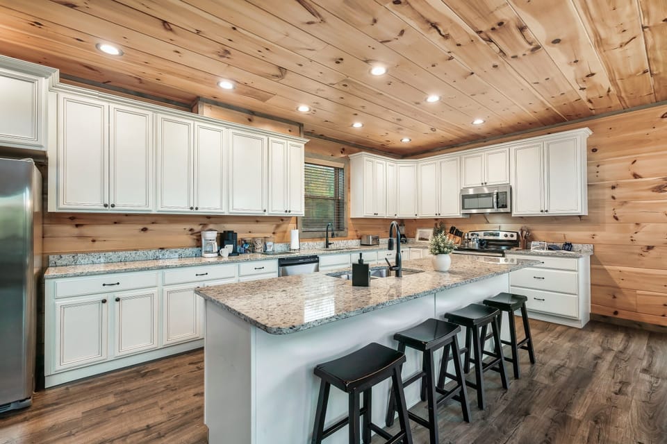 Sleek and modern kitchen with center island table and barstool seating.