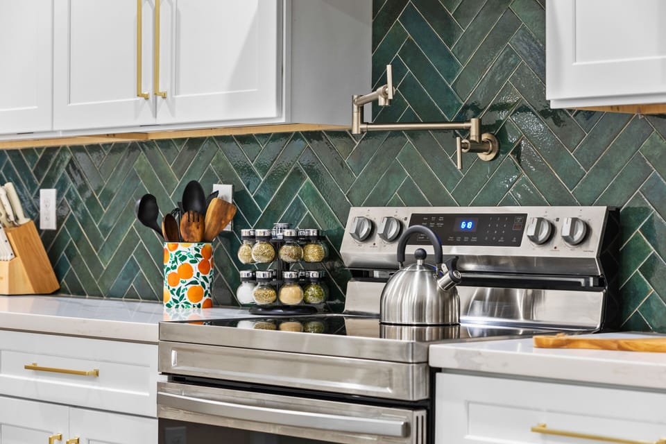 A fully equipped kitchen with a large island, designed for meals, snacks, and time together.