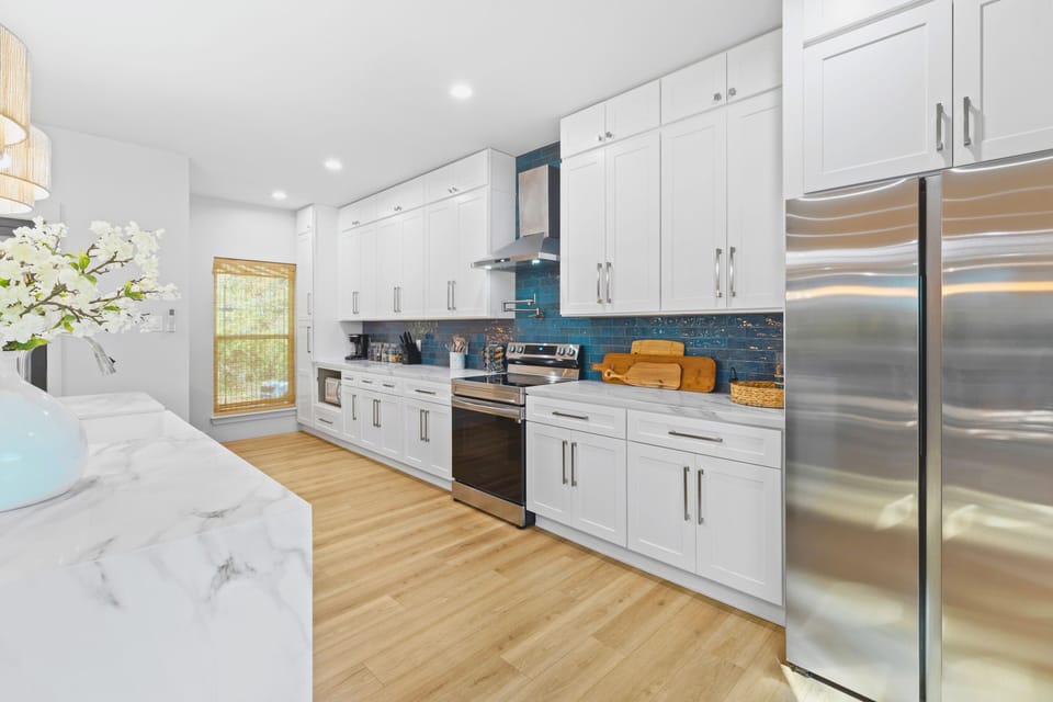 Cook and gather with ease in the fully equipped kitchen, featuring a spacious island that’s perfect for meal prep, casual dining, or enjoying a glass of wine while chatting with friends and family.