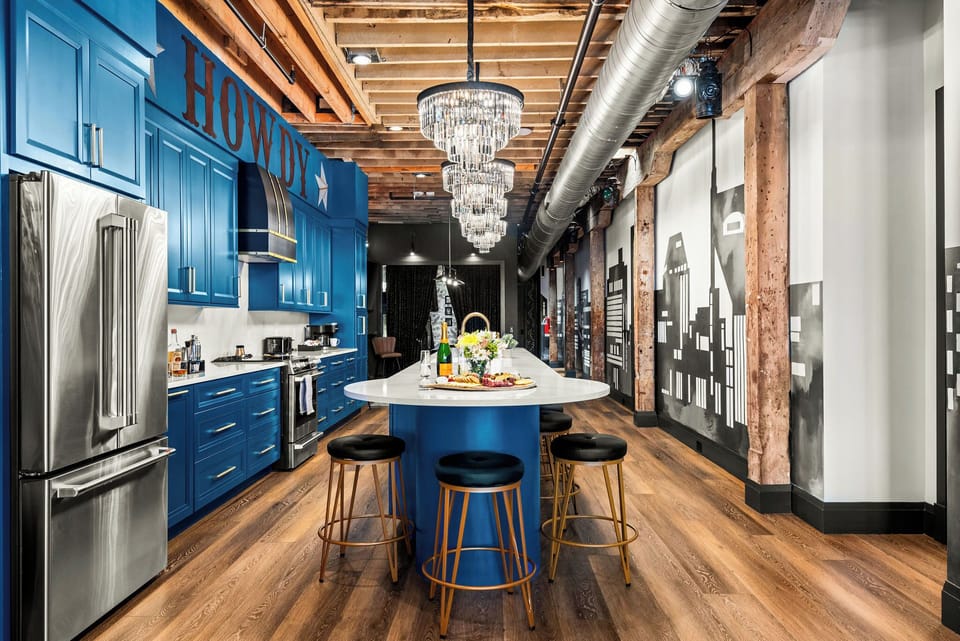 - Blue HOWDY kitchen with long island bar stools and sparkling lighting - Open layout flows into the loft for easy group gatherings - Perfect cooking and hosting space for fun memorable stays