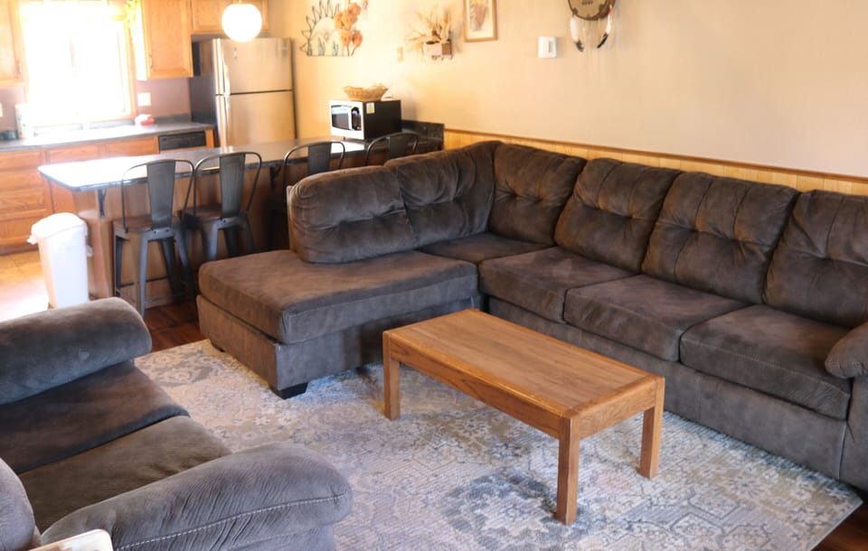 Sink into plush sofas in your open-concept living space, where the kitchen flows seamlessly into the lounge—perfect for cooking, gathering, and unwinding together.
