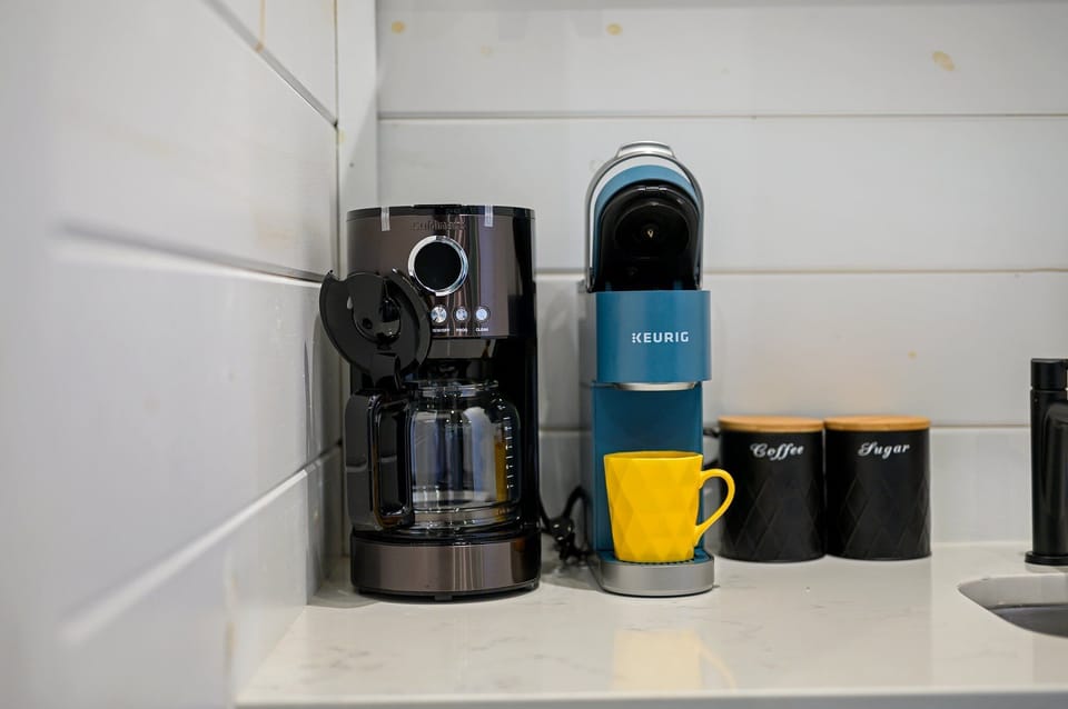 - Brew your way with a Keurig K Cup or Cuisinart Dripe for full carafes - Bright yellow mug and labeled canisters add a playful and functional touch - Coffee lovers will appreciate the variety and convenience of this setup