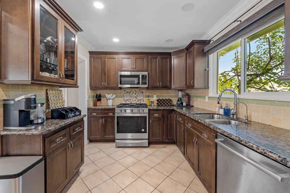 Kitchen area with wooden cabinets and all essentials