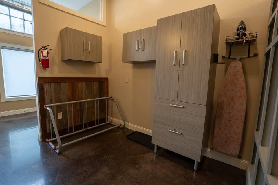 Organized storage space with closet and ironing board