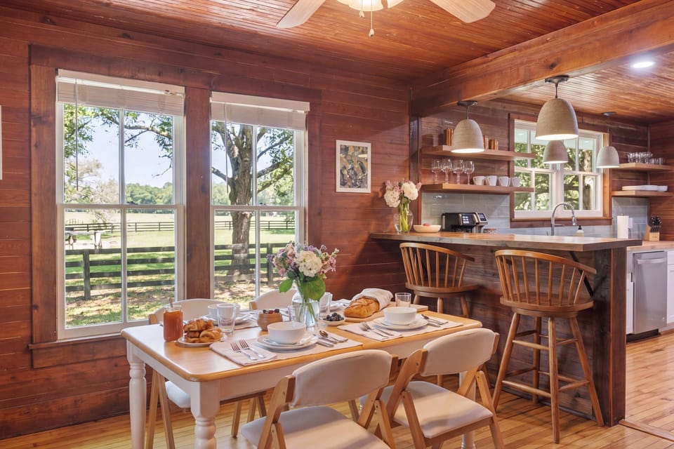 Whether it’s a family brunch or a quiet dinner, our open-concept dining area keeps you connected to both the kitchen and the cozy hearth. With comfortable seating and a warm, wooden aesthetic, it’s the heart of the home’s interior.