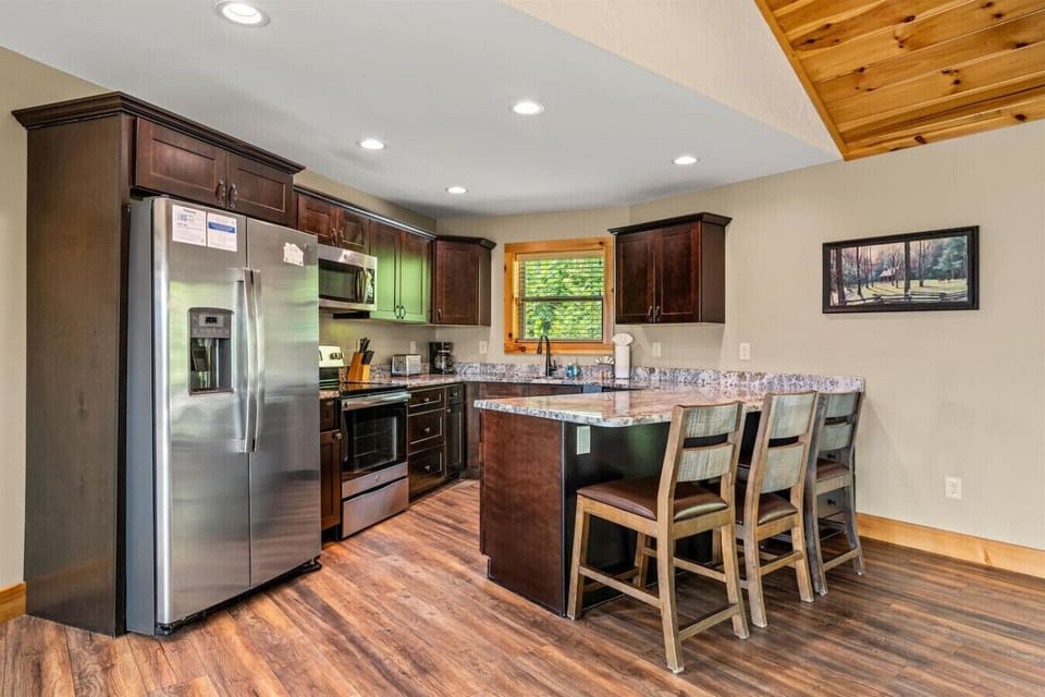 The kitchen flows seamlessly into the living space, making it easy to cook, chat, and stay connected. Rustic finishes add warmth to every corner.