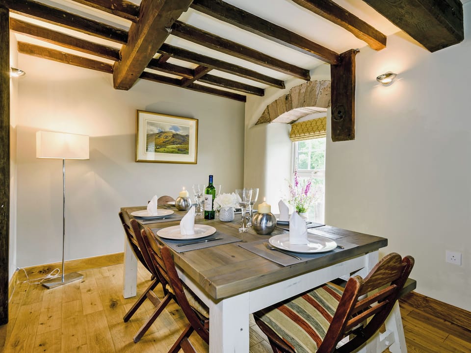 Elegant dining area with views overlooking the river | The Old Mill, Great Strickland near Ullswater