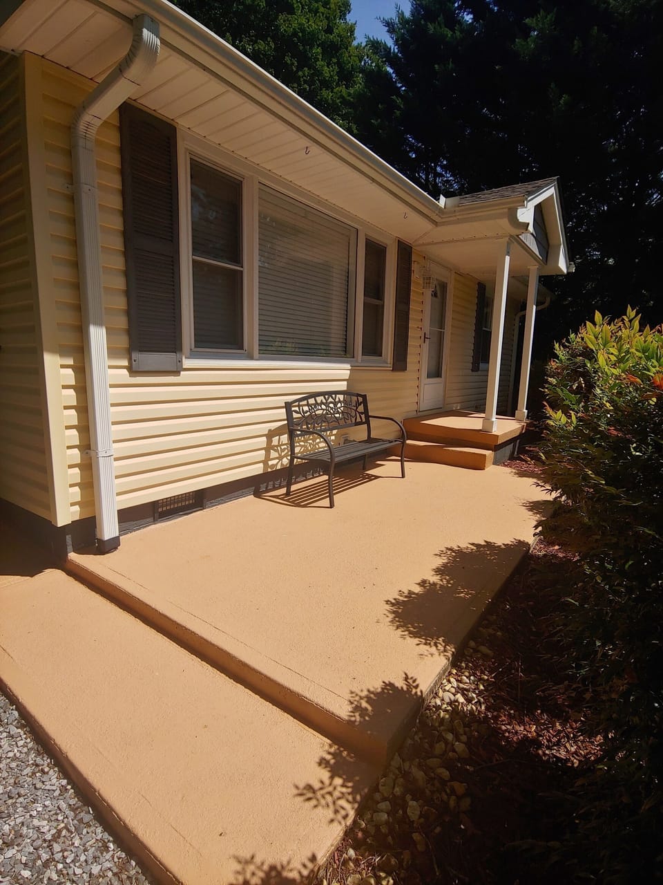 Front Patio seating with privacy thanks to shrubs. 