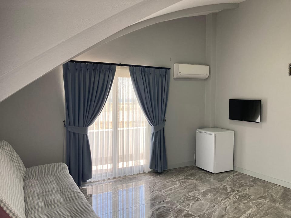 Family Penthouse, Sea View | Living area | 25-inch TV with premium channels
