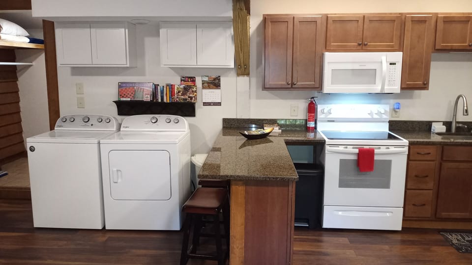 Laundry area.  Games and books for children. small bar area with 2 bar stools.