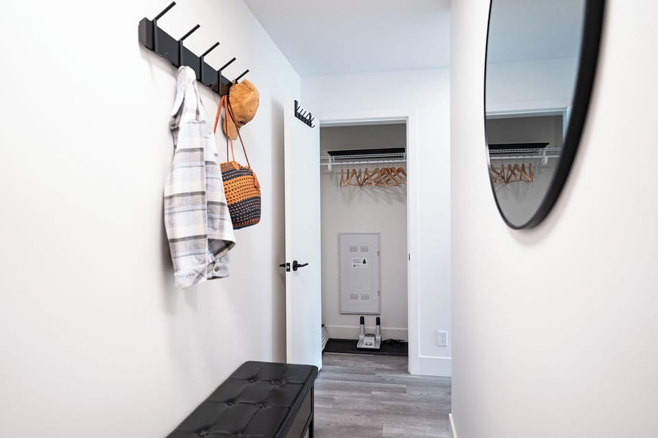 Entryway with coat closet, bench and boot driers for the winter season