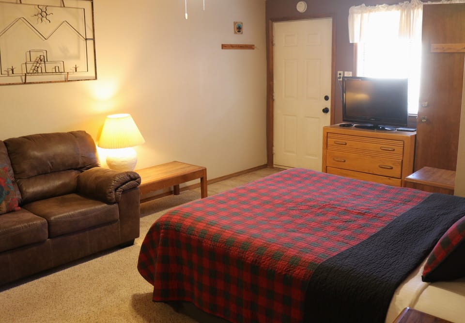 Unwind in your cozy retreat with a plush armchair, warm lighting, and all the comforts of home. Your mountain getaway awaits with rustic charm and modern convenience.