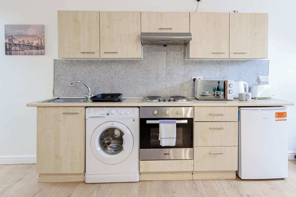 Enjoy cooking in our fully equipped kitchen. It is indeed perfect for long-term stays, washer is also in the unit.