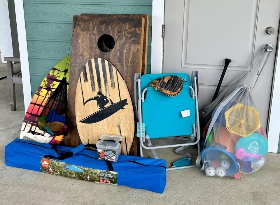 Beach toys, corn hole, canopy, and 4 folding chairs are available for guests to 