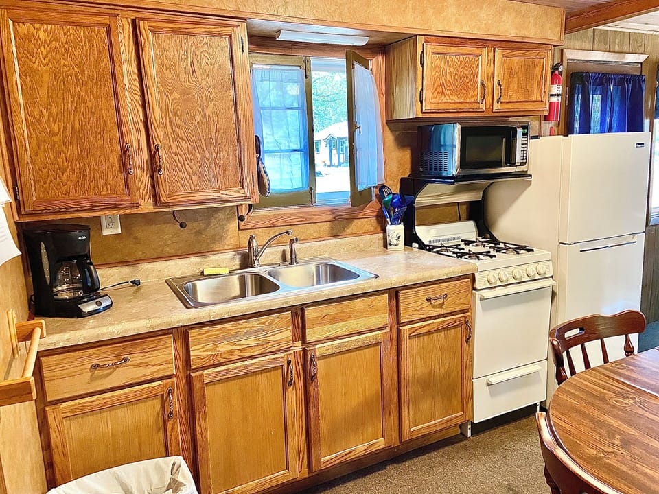 Kitchen with Stove, Oven, Microwave, Coffee Maker, Dishes, and Utensils