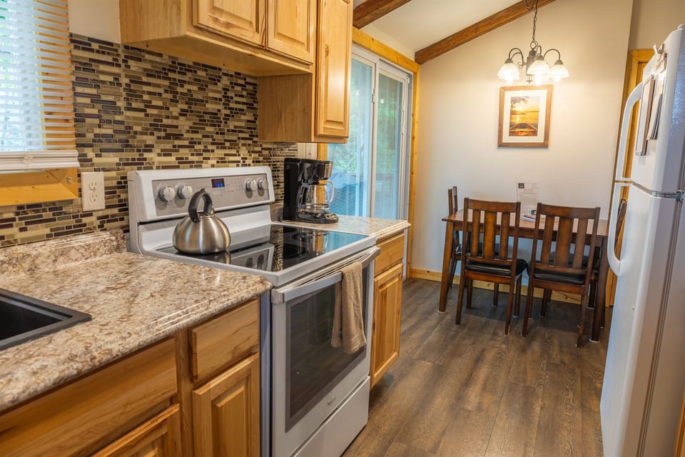 Upstairs kitchen and dining area with slider going to deck